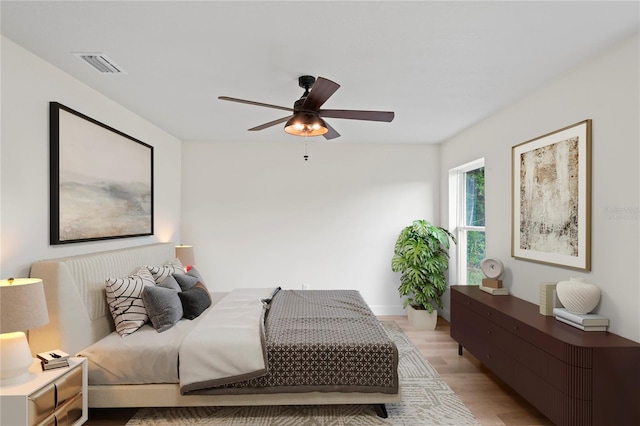 bedroom with ceiling fan and light hardwood / wood-style flooring