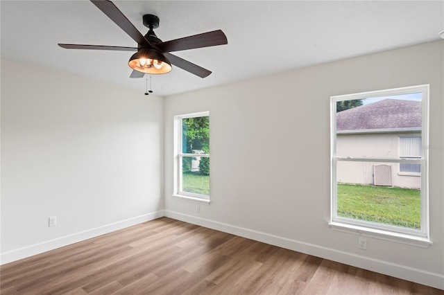 spare room with ceiling fan and light wood-type flooring