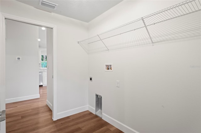 laundry room featuring wood-type flooring, electric dryer hookup, and washer hookup