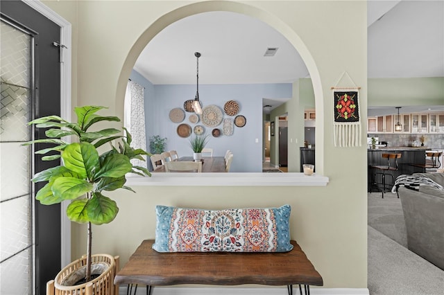 interior space featuring carpet flooring and backsplash