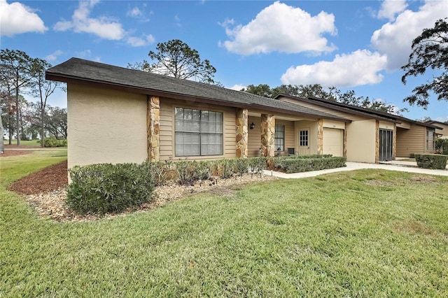 single story home featuring a garage and a front yard