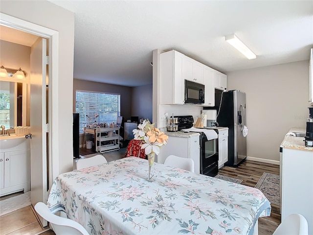 bedroom featuring sink and stainless steel fridge with ice dispenser