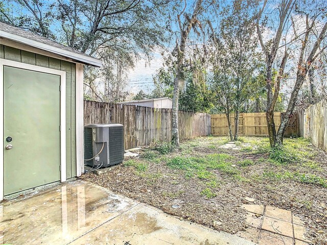 view of yard featuring central AC unit and a patio