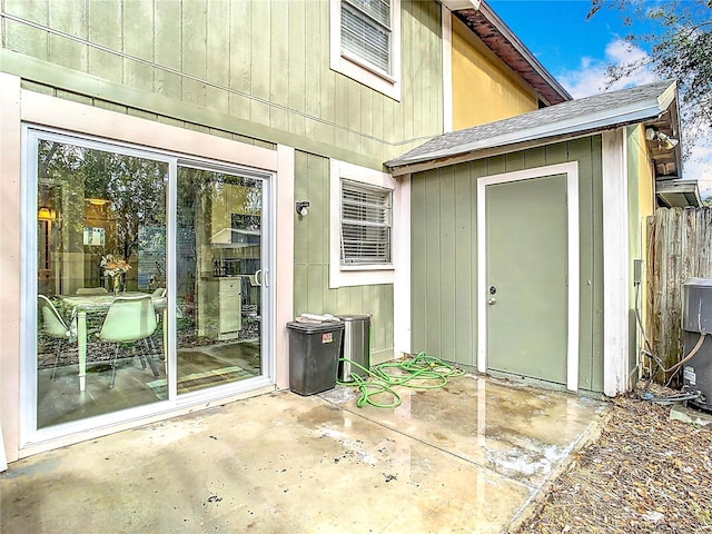 view of exterior entry with a patio area