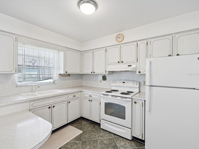 kitchen featuring sink, white cabinets, white appliances, and dark tile patterned flooring