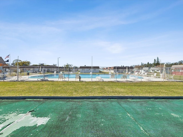 view of community with a pool and a lawn