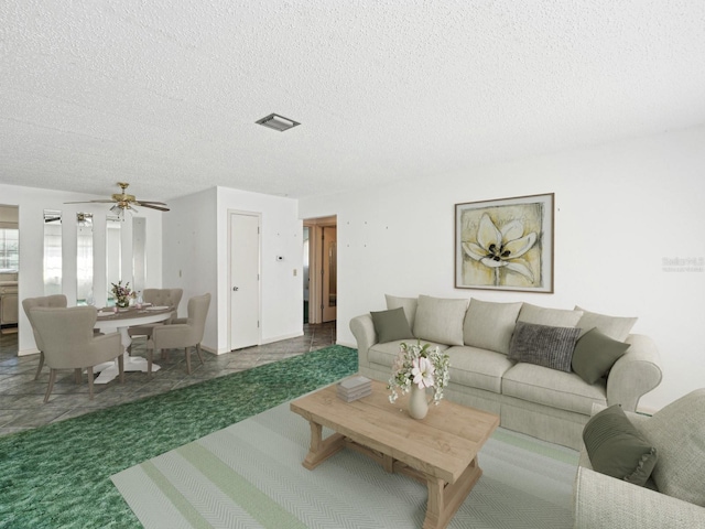 7037 Versailles N Unit 15, Pinellas Park, FL 33781 - living room featuring a textured ceiling, a ceiling fan, and carpet