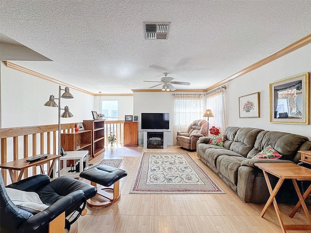 1203 Clays Trl Unit 406, Oldsmar, FL 34677 - living room with a textured ceiling, light wood-style floors, visible vents, and crown molding