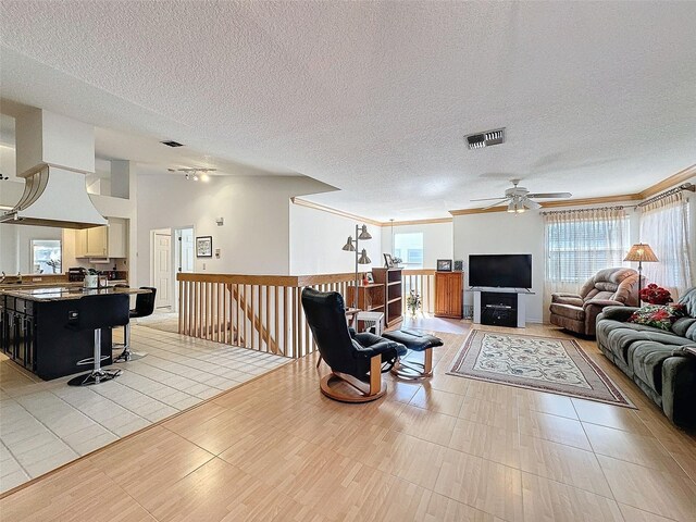 1203 Clays Trl Unit 406, Oldsmar, FL 34677 - living room featuring a textured ceiling, light tile patterned floors, visible vents, and a ceiling fan