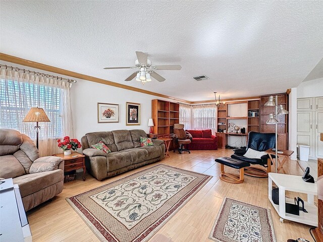 1203 Clays Trl Unit 406, Oldsmar, FL 34677 - living room with a ceiling fan, visible vents, crown molding, and a textured ceiling