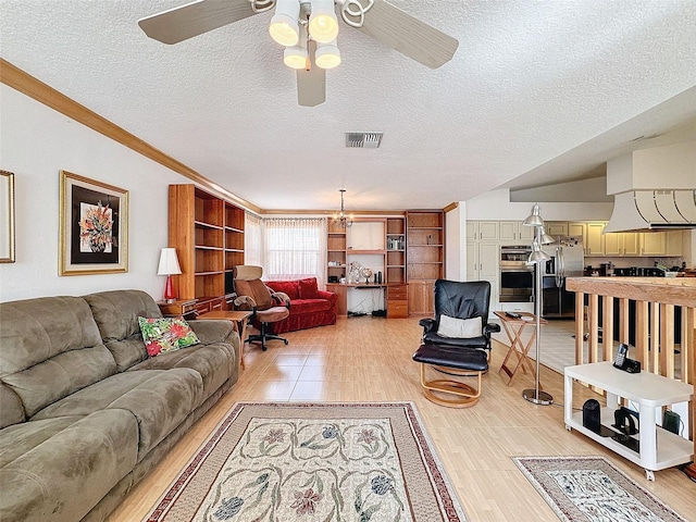 1203 Clays Trl Unit 406, Oldsmar, FL 34677 - living area with visible vents, a textured ceiling, light wood finished floors, and ceiling fan with notable chandelier