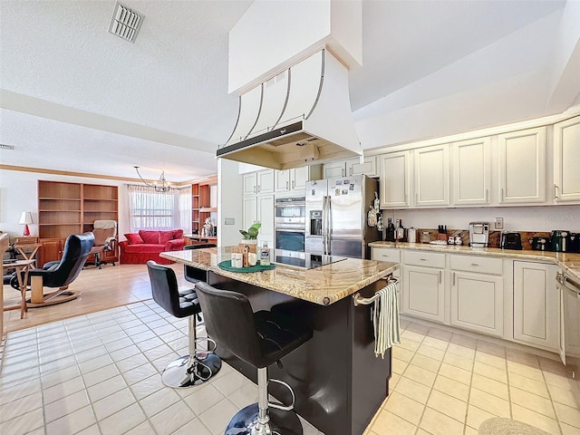 1203 Clays Trl Unit 406, Oldsmar, FL 34677 - kitchen with light tile patterned floors, visible vents, appliances with stainless steel finishes, open floor plan, and a kitchen bar