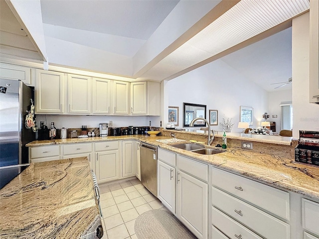 1203 Clays Trl Unit 406, Oldsmar, FL 34677 - kitchen with light tile patterned floors, dishwasher, light stone counters, freestanding refrigerator, and a sink
