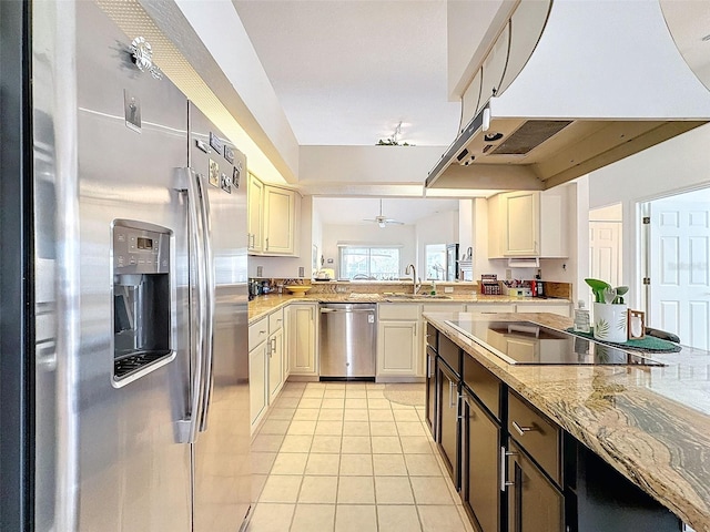 1203 Clays Trl Unit 406, Oldsmar, FL 34677 - kitchen featuring range hood, light tile patterned floors, stainless steel appliances, a sink, and light stone countertops