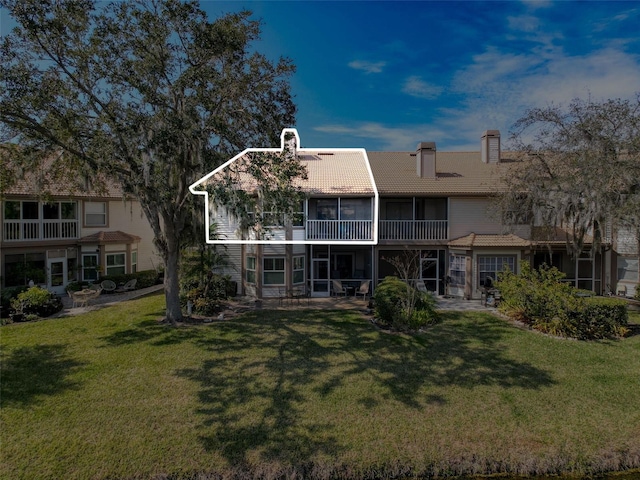 1203 Clays Trl Unit 406, Oldsmar, FL 34677 - back of property with a yard, a sunroom, a chimney, and a tiled roof