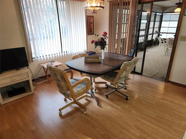 dining room with a notable chandelier and light wood-type flooring