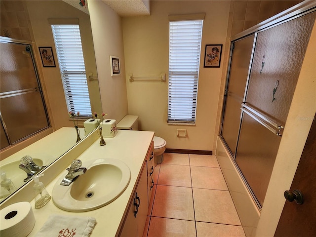 full bathroom with tile patterned flooring, vanity, plenty of natural light, and toilet