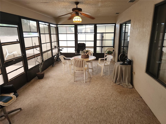 sunroom / solarium featuring ceiling fan