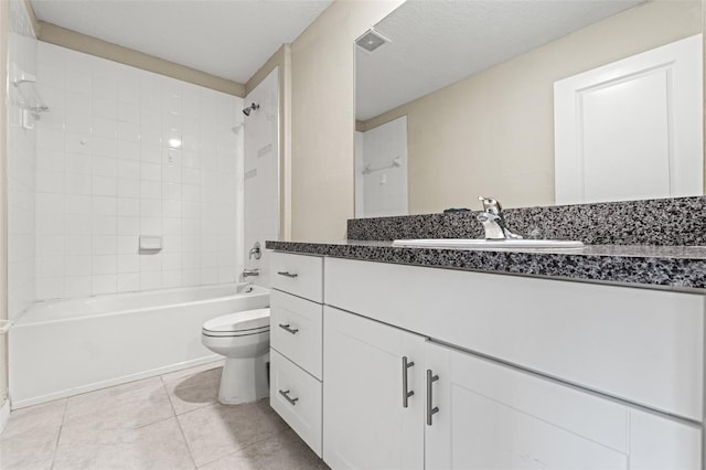 full bathroom featuring tiled shower / bath, vanity, toilet, tile patterned floors, and a textured ceiling