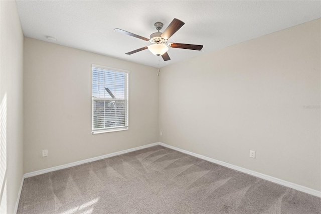 empty room featuring carpet, a textured ceiling, and ceiling fan