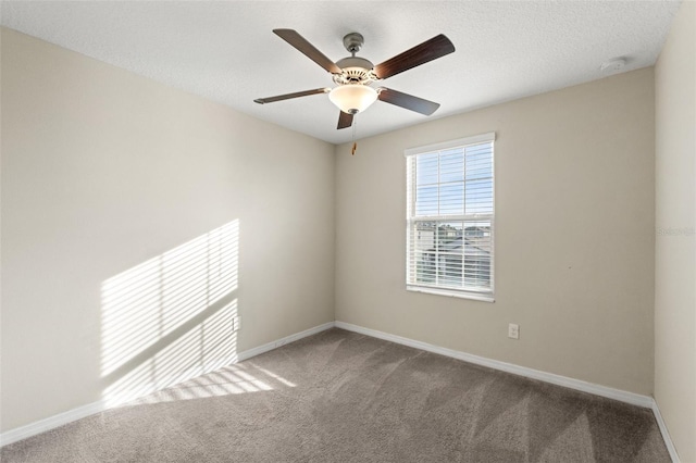 carpeted empty room with a textured ceiling and ceiling fan