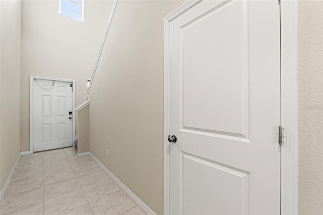 hallway featuring light tile patterned floors