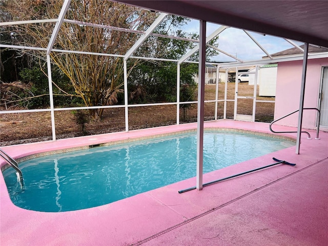 view of swimming pool featuring a patio area and glass enclosure