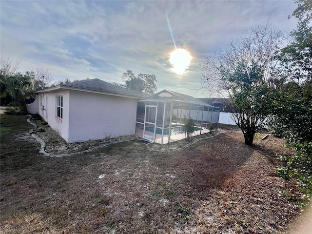 view of home's exterior with a pool