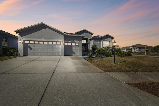 view of front of house with a yard and a garage