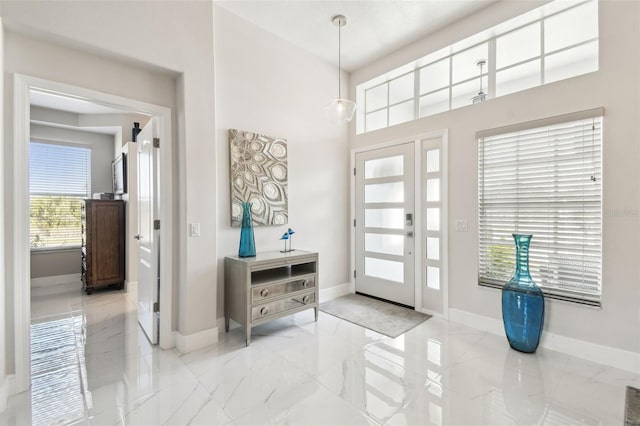 foyer entrance featuring a towering ceiling