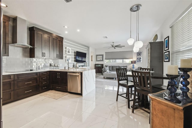 kitchen featuring decorative light fixtures, dishwasher, backsplash, ceiling fan, and wall chimney exhaust hood