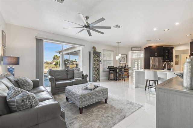 living room with sink and ceiling fan