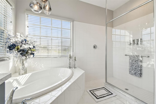 bathroom with plenty of natural light and independent shower and bath