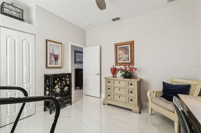 living area featuring ceiling fan