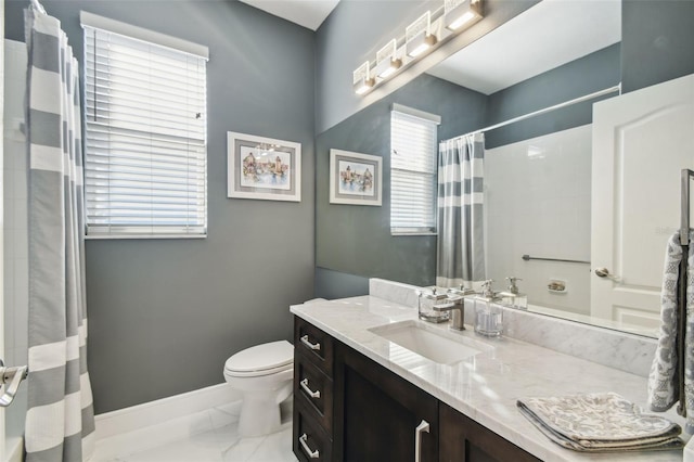 bathroom featuring vanity, walk in shower, and toilet