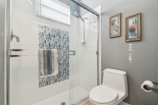 bathroom featuring toilet and walk in shower