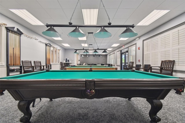 recreation room featuring carpet flooring and a drop ceiling