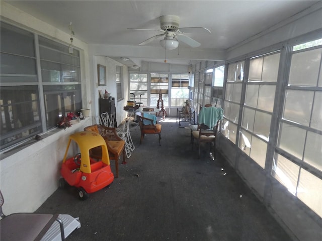 unfurnished sunroom featuring ceiling fan