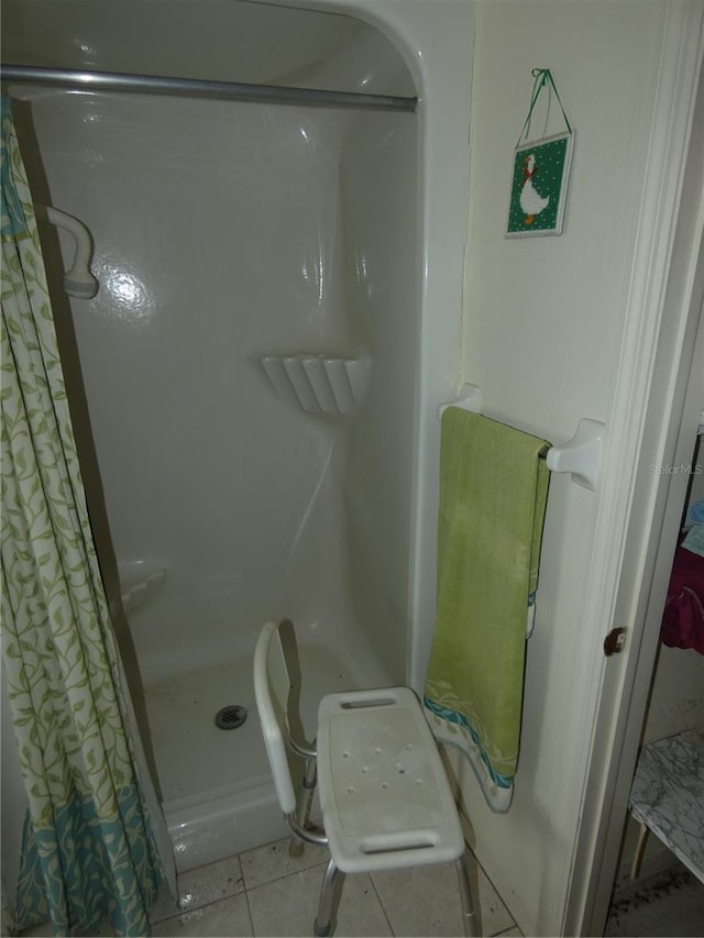 13737 Michelle Ave, Hudson, FL 34667 - bathroom with a shower with curtain and tile patterned floors