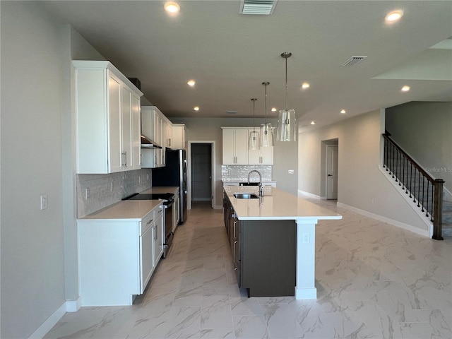 kitchen featuring marble finish floor, recessed lighting, visible vents, electric range, and a sink