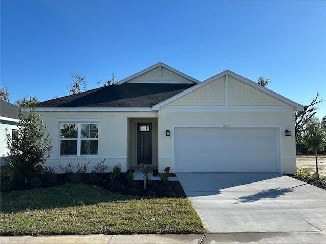 view of front of home with a garage and a front yard