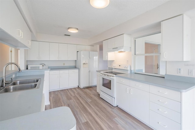 kitchen with white cabinetry, sink, white appliances, and a textured ceiling