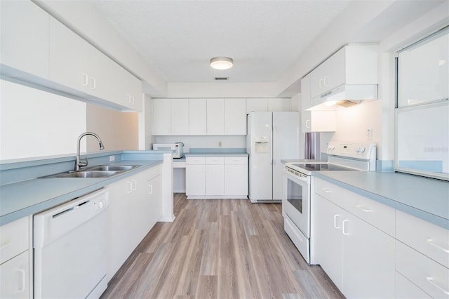 kitchen with sink, white cabinetry, a textured ceiling, white appliances, and light hardwood / wood-style floors