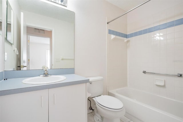 full bathroom featuring tiled shower / bath combo, vanity, tile patterned flooring, toilet, and a textured ceiling