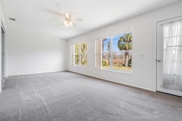 interior space with ceiling fan and a textured ceiling