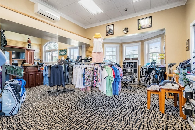 interior space featuring ornamental molding, carpet floors, and a wall mounted air conditioner