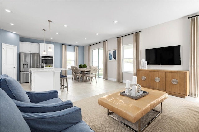 living room with plenty of natural light and light tile patterned floors