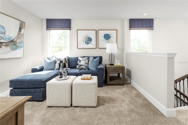 living room with plenty of natural light and light colored carpet