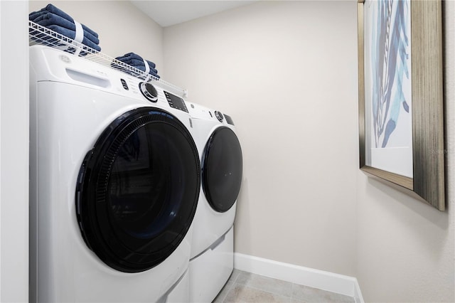 washroom with washing machine and dryer and light tile patterned floors