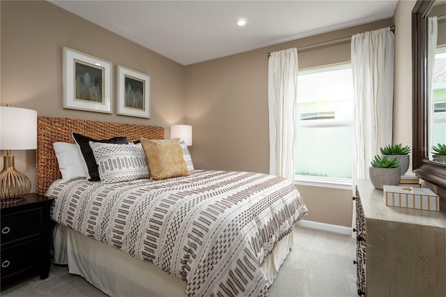 bedroom featuring light colored carpet